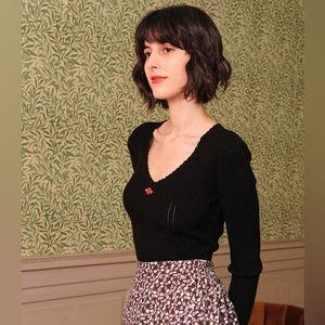 Rihoas Wavy Knit Ribbed Sweetheart Sweater with red rosette appliqué